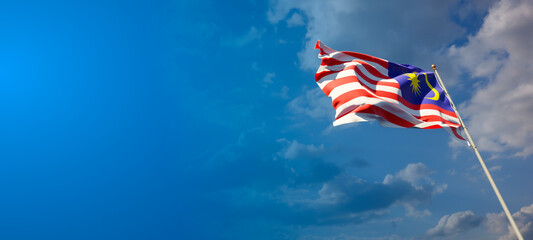 Malaysia national flag with blank text space on wide background.