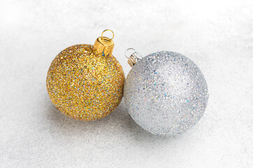 Christmas ornaments of gold and silver ball with blurred textured background