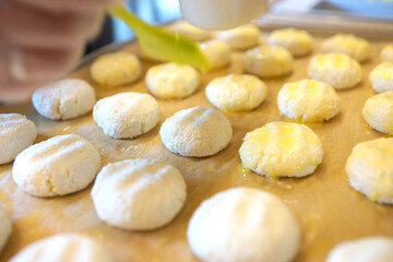 The process of making cheese cakes. Cheesecakes on a baking sheet before baking.