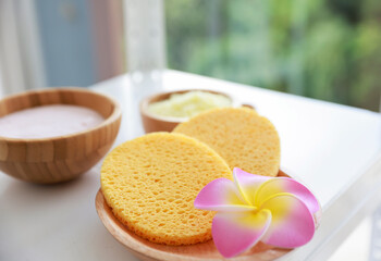 Natural fiber facial cleansing sponge with soap foam bubbles. Health & Beauty concept.