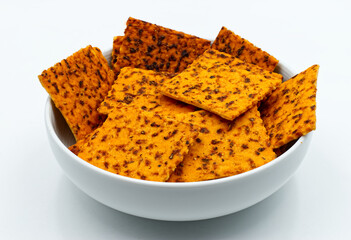 Crackers with tomato in a white bowl isolated on white background