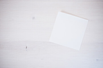 White blank memo on a white textured surface - abstract backgrounds with space for your text