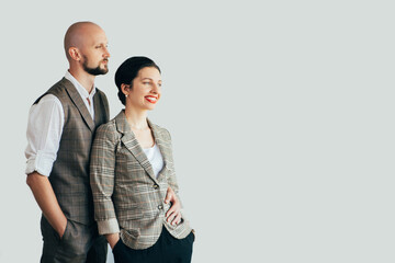 Hipster elegance. Family look. Trend fashion. Happy beloved man and woman in casual classic outfit hands in pocket isolated on white copy space. Advertising background.