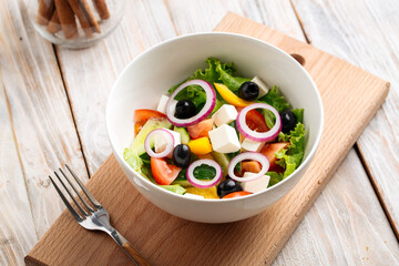 Fresh vegetables greek salad in a white bowl