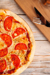 Closeup on margherita pizza with tomatoes 