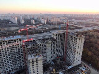 Aerial view construction of a high-rise business center in the big city. Beautiful panoramic landscape of the city at dawn from a height.