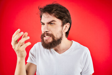 bearded man gesturing with hands white t-shirt emotions facial expression aggression red isolated background