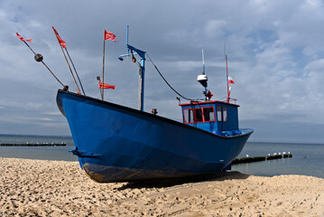 A fishing boat on the shores of the Baltic Sea - obrazy, fototapety, plakaty