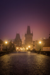 Fototapeta na wymiar Charles Bridge in the early morning fog in Prague, Czech Republic
