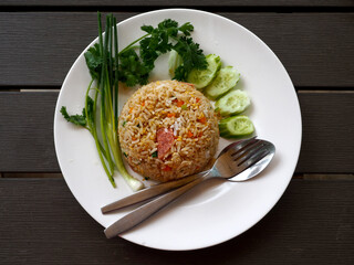 top view of stir fried rice with fermented pork on dark wooden background