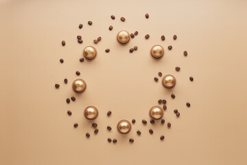 Caffeine, hot drinks and objects concept - close up of golden capsules or pods for coffee mashine with some roasted grains on beige background. Top view with space for text. Flat lay..