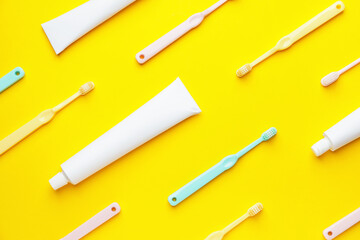 Toothbrushes and paste on color background