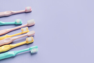 Toothbrushes on color background