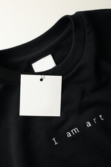 Stylish blank black sweatshirt on white table