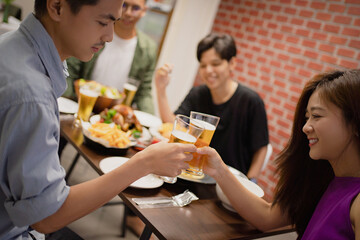 Asian friends having a party to celebrate the festival. They are drinking beer.