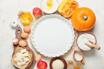 Ingredients for preparing pumpkin pie and baking dish on light background