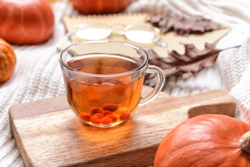 Cup of viburnum tea on bed