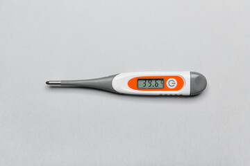 Electronic thermometer on light background