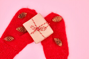 Christmas or New Year gift box is on the red mittens