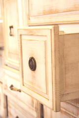 Antique, wooden chest of drawers in a restaurant. Many drawers with iron handles. Close up