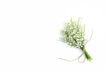 Bouquet of lilies of the valley on white background. Flat lay, top view, copy space. floral background with spring flowers. Minimalism fashion style