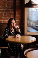 Portrait of beautiful woman drinking a cup of coffee