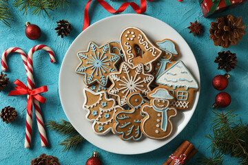 Plate with delicious Christmas cookies on blue background