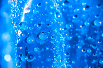 raindrops on a plastic tape blue close-up. water droplets on the surface in macro photography. abstract background