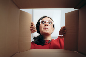 Curious Woman Looking Inside Cardboard Gift Box