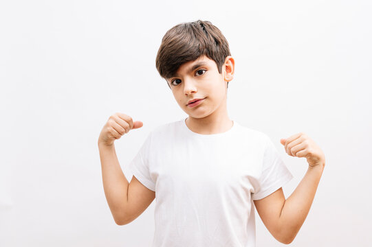 Little Boy Hispanic Kid Wearing Casual White Tshirt Very Happy And Excited Doing Winner Gesture With Arms Raised, Smiling And Screaming For Success. Celebration Concept.