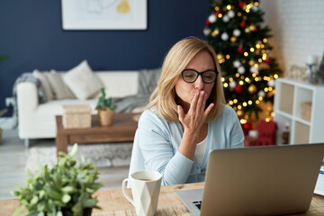 Mature woman sending kisses during video conference at home