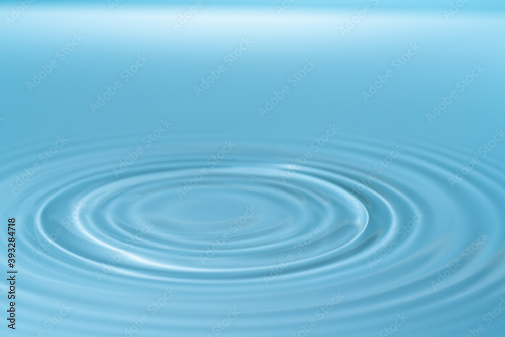 Wall mural drop of water drop to the surface. waves on the surface of the water from a collision