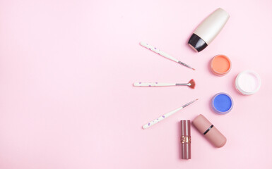 Beautiful cosmetic accessories on a pink background.