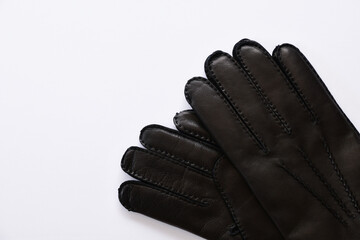 Black leather gloves on white background.
