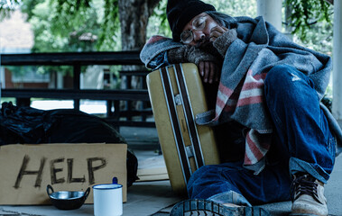 Homeless man  waits for help or share