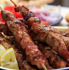 Grilled meat skewers on a table, closeup view