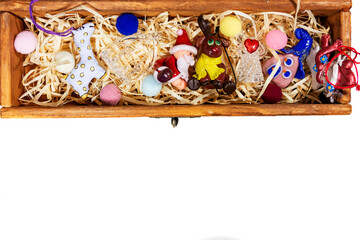 Christmas toys in a wooden decorative box on a white background