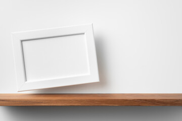 horizontal white wood photo on bookshelf and wall