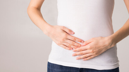 young beautiful woman holding her belly. abdominal pain