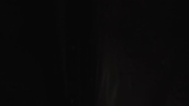 Hospital morgue. Doctor closes plastic bag with a dead body inside. A corpse in a black plastic bag POV view on green screen background.