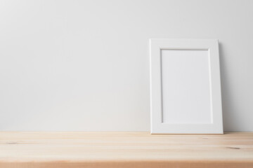 vertical white wood photo on floor with white wall
