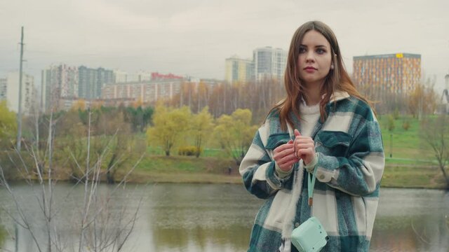 Teen girl is waiting for somebody with camera. Red Helium 8K