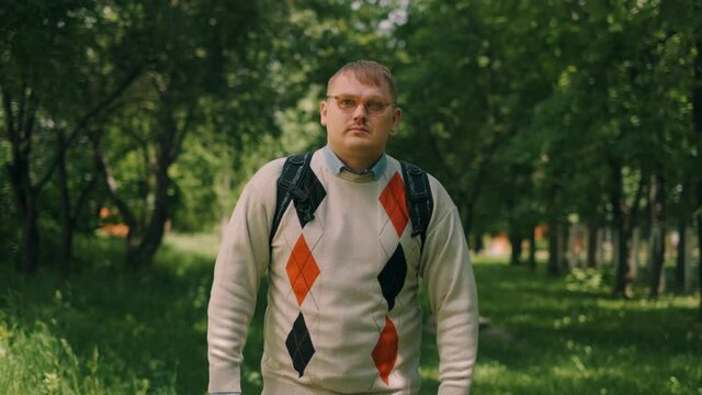 Nerdy fat guy is walking to school. Concept of loser nerd at university.