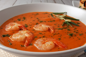 Bean puree soup with tomatoes, shrimps and rosemary. Diet food.