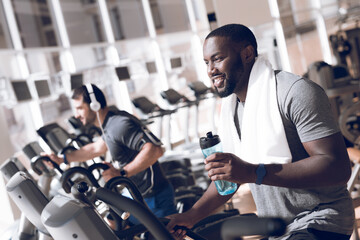 Fototapeta na wymiar Two men are engaged on treadmills in modern gym.