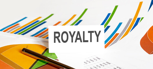 ROYALTY text on paper on chart background with pen
