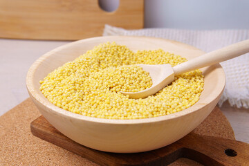 millet groats in wooden bowl. nutrition bio. natural food ingredient.