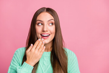 Close up photo of adorable person look empty space hand near chin teal sweater isolated on pink...