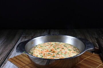 Traditional steamed egg (Egg custard) with chopped fresh carrot and spring onion in the bowl. Famous breakfast menu in Asia restaurant. Vegetarian menu concept.
