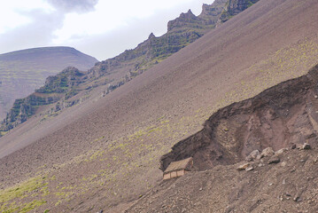 small wooden building on a mountainside, nature of Iceland